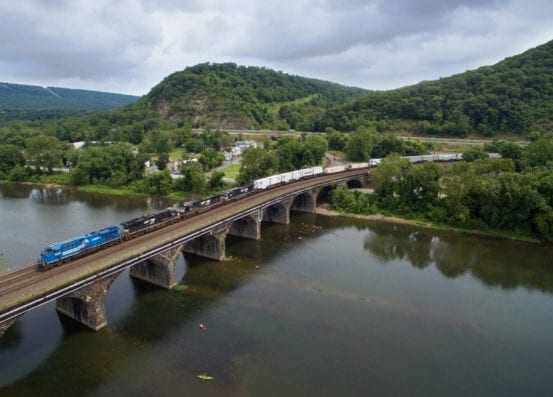 Another cloudy day as the Conrail heritage unit passes over the Rockville Bridge