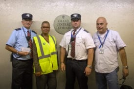 The crew of Train 235 pose next to the Grand Central platform sign