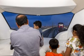 Passengers enjoy the view from the end of the train
